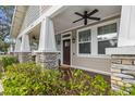 Front porch detail with wood flooring and seating at 408 E Flora St, Tampa, FL 33604