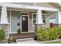 Front porch with stone columns and ceiling fan at 408 E Flora St, Tampa, FL 33604