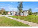 House exterior showcasing a well-maintained lawn and landscaping at 8404 Millwood Dr, Hudson, FL 34667