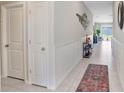 Inviting hallway with neutral tones, tiled floors, and decorative accents, creating a warm and welcoming atmosphere at 9407 Channing Hill Dr, Ruskin, FL 33573