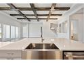 Open-concept kitchen with stainless steel appliances, a large island, and view of the living room at 17525 Glistening Ct, Venice, FL 34293