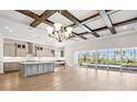 Gourmet kitchen and a clear view to the pool through sliding glass doors from the open concept layout at 17525 Glistening Ct, Venice, FL 34293