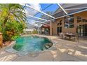 Inviting screened pool area with a patio and outdoor dining at 1858 Longview Ln, Tarpon Springs, FL 34689