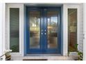 Inviting blue front door with glass panels and sidelights, welcoming you home at 2516 Roberta St, Largo, FL 33771