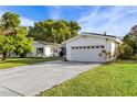 Single-story home with a two-car garage and well-maintained lawn at 2516 Roberta St, Largo, FL 33771
