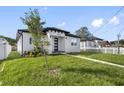 Newly built home with a grassy yard and walkway at 2714 W Walnut St, Tampa, FL 33607