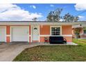 Exterior of one unit in a duplex, showing garage and porch at 3332 W Heiter St, Tampa, FL 33607
