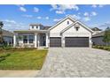Beautiful home with a two-car garage and a neatly paved driveway at 18096 Foxtail Loop, Venice, FL 34293