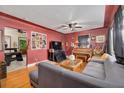 Living room with hardwood floors, gray sectional sofa, and a piano at 1840 21St N Ave, St Petersburg, FL 33713