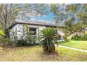 House exterior showcasing a white stucco facade, lush landscaping, and a walkway at 1840 21St N Ave, St Petersburg, FL 33713