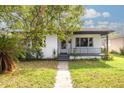 A charming white house with a black roof, walkway, and small front yard at 1840 21St N Ave, St Petersburg, FL 33713