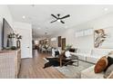 Spacious living room featuring a ceiling fan, hardwood floors, and a dining area in the background at 3035 1St S Ave, St Petersburg, FL 33712