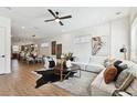 Bright living room offering hardwood floors and modern decor that transitions to a dining and kitchen area at 3035 1St S Ave, St Petersburg, FL 33712