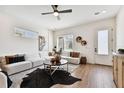 Comfortable living room featuring hardwood floors, a ceiling fan, and stylish, modern decor at 3035 1St S Ave, St Petersburg, FL 33712