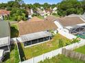 Aerial view showcasing the house, backyard, and a screened patio at 9708 Little Pond Way, Tampa, FL 33647