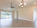 Spacious Gathering room featuring tile floors, ceiling fan, and sliding glass doors at 411 Seasons Dr, Punta Gorda, FL 33983
