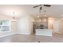 Modern kitchen with gray cabinets, quartz countertops, and stainless steel appliances at 411 Seasons Dr, Punta Gorda, FL 33983