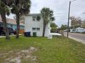 View of exterior showing green lawn, palm trees and newly painted exterior at 301 W Chelsea St, Tampa, FL 33603