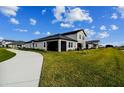 Two-story house with a screened patio and a landscaped yard at 31422 Briars Ml, San Antonio, FL 33576