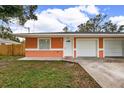 Orange duplex with attached garages at 3330 W Heiter St, Tampa, FL 33607