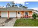 Orange duplex with a 2 car garage and front porch at 3336 W Heiter St, Tampa, FL 33607