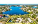 Waterfront estate with expansive grounds, pool, and lush landscaping, outlined in yellow at 518 Riverside Dr, Tarpon Springs, FL 34689