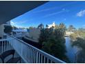 Balcony view overlooking a tranquil waterway, lush foliage, and resort amenities at 5500 Gulf Blvd # 2235, St Pete Beach, FL 33706