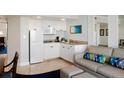 Well-equipped kitchenette with white cabinets, microwave, and stovetop at 5500 Gulf Blvd # 2235, St Pete Beach, FL 33706