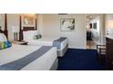 Bedroom with two double beds, updated decor, and access to another room at 5500 Gulf Blvd # 2235, St Pete Beach, FL 33706