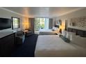 Guest bedroom with two double beds, balcony access, and sitting area at 5500 Gulf Blvd # 2237, St Pete Beach, FL 33706