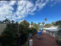 View from balcony showcases lush landscaping and courtyard seating at 5500 Gulf Blvd # 2237, St Pete Beach, FL 33706
