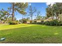 Yellow house with a large front yard and lush green grass at 1480 N Russell Dr, St Petersburg, FL 33710