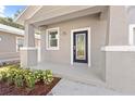 Charming front porch with a black door and white trim at 1815 E 22Nd Ave, Tampa, FL 33605