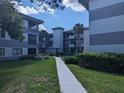 Condo building exterior showcasing a well-maintained property at 2650 Countryside Blvd # A307, Clearwater, FL 33761