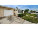 White garage door and driveway of tan house at 2739 Sherbrooke Ln # B, Palm Harbor, FL 34684