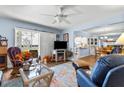 Spacious living room featuring fireplace, comfy seating, and access to patio at 3970 37Th S St # 14, St Petersburg, FL 33711
