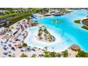 Large lagoon-style community pool with a sandy beach and water features at 8968 Parsons Hill Blvd, Wesley Chapel, FL 33545