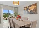Bright dining room with sliding glass doors leading to the backyard at 8968 Parsons Hill Blvd, Wesley Chapel, FL 33545