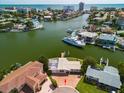 Wide aerial showcasing waterfront home, neighborhood, and waterway at 17444 2Nd E St, Redington Shores, FL 33708