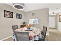 Charming dining area with round table, floral tablecloth, and pass-through view to the adjacent well-lit kitchen at 200 Glennes Ln # 111, Dunedin, FL 34698