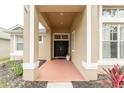 Covered entryway with double doors and terracotta-colored flooring at 2622 Bonterra Blvd, Valrico, FL 33594