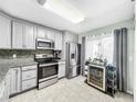 Updated kitchen featuring stainless steel appliances and granite countertops at 2920 Star Apple Ct, Palm Harbor, FL 34684