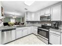 Modern kitchen with stainless steel appliances and granite countertops at 2920 Star Apple Ct, Palm Harbor, FL 34684
