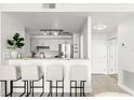 Bright kitchen area features modern cabinets and stainless steel appliances, open to the living area with bar seating at 345 Bayshore Blvd # 1104, Tampa, FL 33606