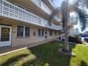 Condo building exterior, featuring landscaped grounds and balcony at 4915 Bay Ne St # 122, St Petersburg, FL 33703