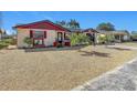 Red and white house with palm trees in the front yard at 5930 Della Dr, Holiday, FL 34690