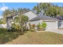 Curb appeal abounds in this one-story house with a two-car garage and neatly landscaped yard at 639 Somerstone Dr, Valrico, FL 33594