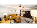 Bright living room with mustard-colored sofas and mid-century modern decor at 130 63Rd S St, St Petersburg, FL 33707