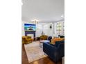 Bright living room with a decorative fireplace, plush seating, and ample natural light at 206 W Frierson Ave, Tampa, FL 33603