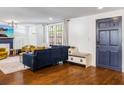 Inviting living room featuring hardwood floors, comfortable seating, and a stylish blue accent door at 206 W Frierson Ave, Tampa, FL 33603